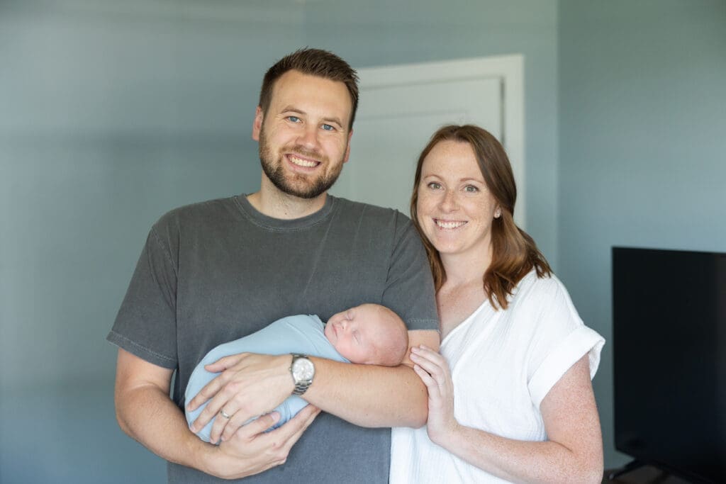 Newborn baby with his parents during a lifestyle photo session in Milwaukee.