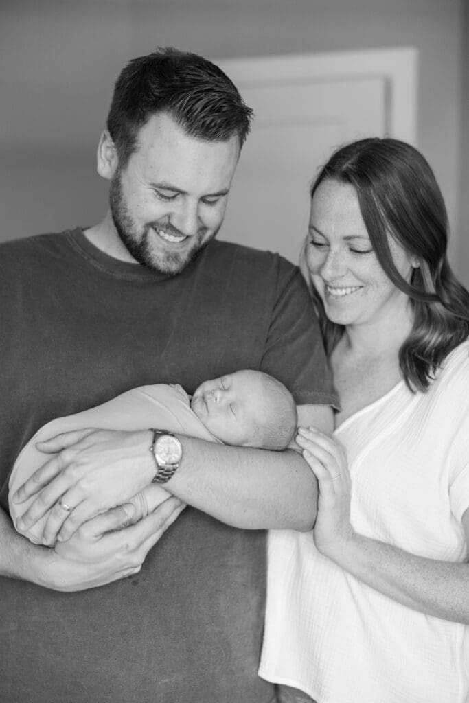 Black and white photograph of newborn with both mom and dad.