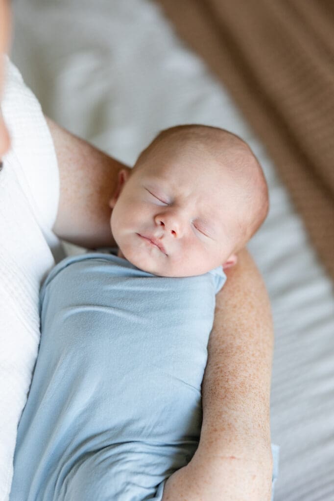 Close up of a newborn baby boy during a at home lifestyle photography session.