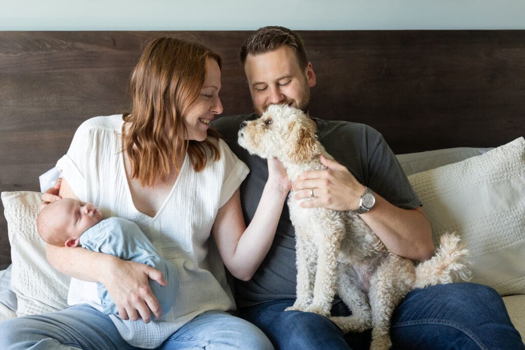 Newborn parents cuddling their new baby in their cozy home.