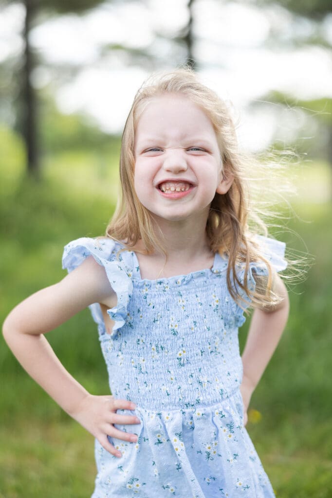 An up close picture of a young girl smiling candidly at the camera.