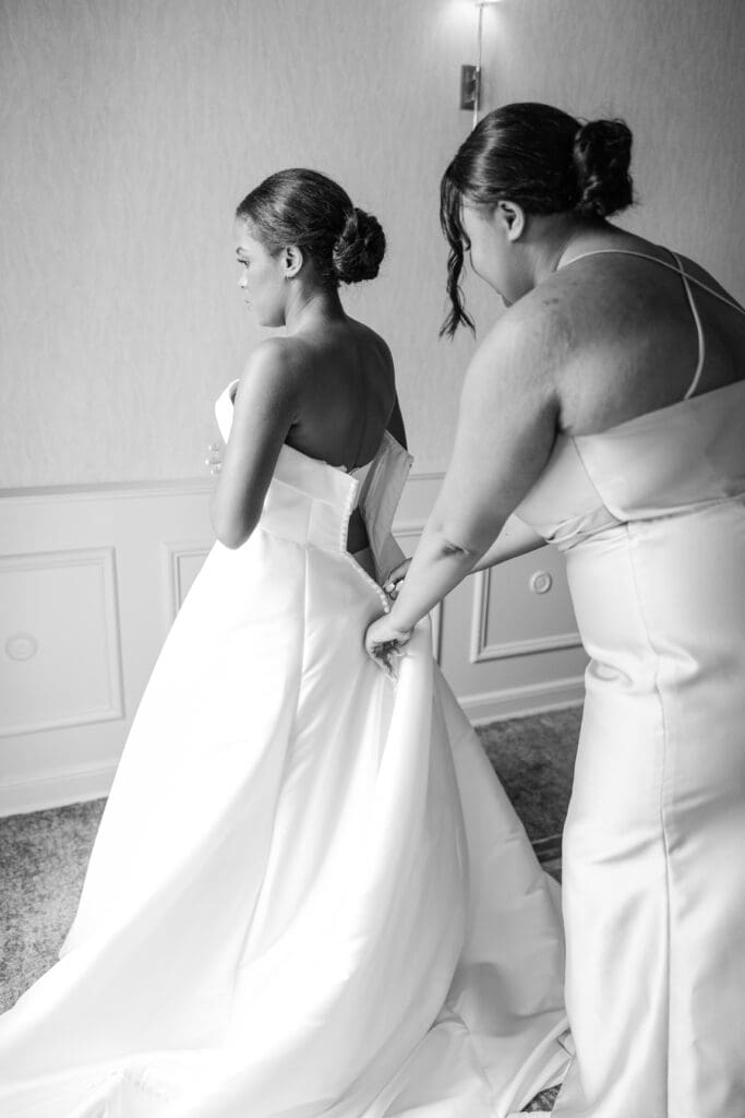 Putting wedding dress on. 