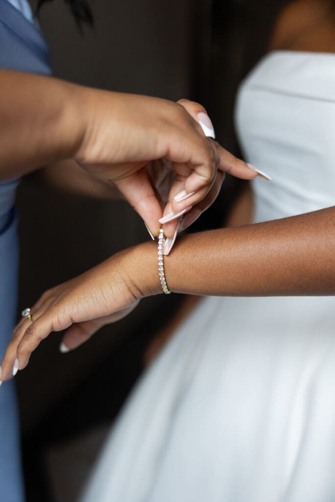 Putting a bracelet on the bride. 