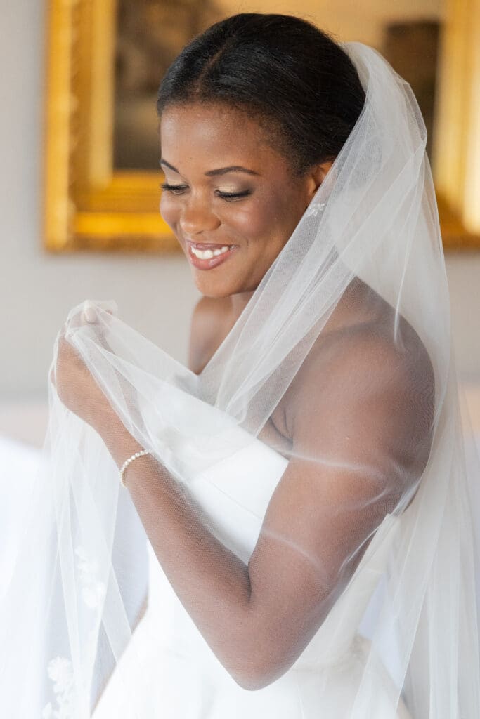 Bride wrapped in her veil.