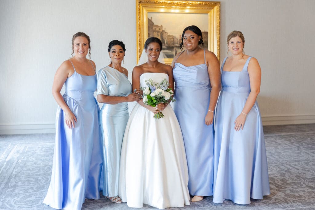 Bride and bridesmaids all dressed up and ready for the wedding.