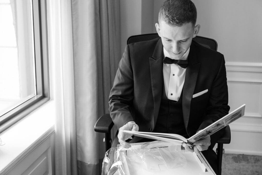 Groom looking at a gift that was sent by his bride on their wedding day. 