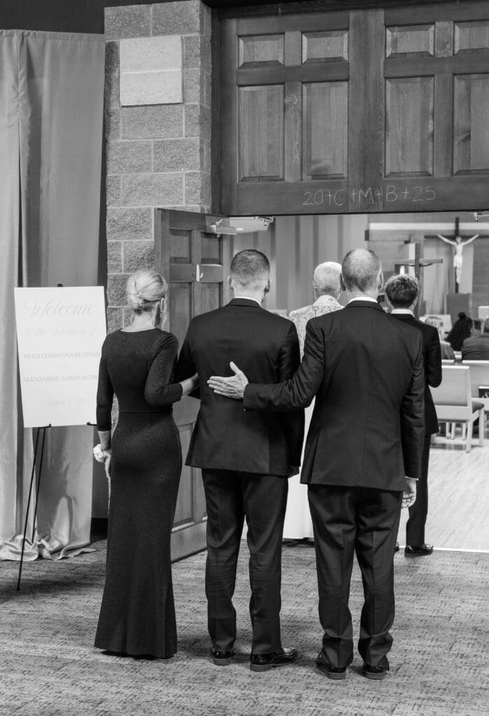 Groom about to walk down the isle with both his mother and father.