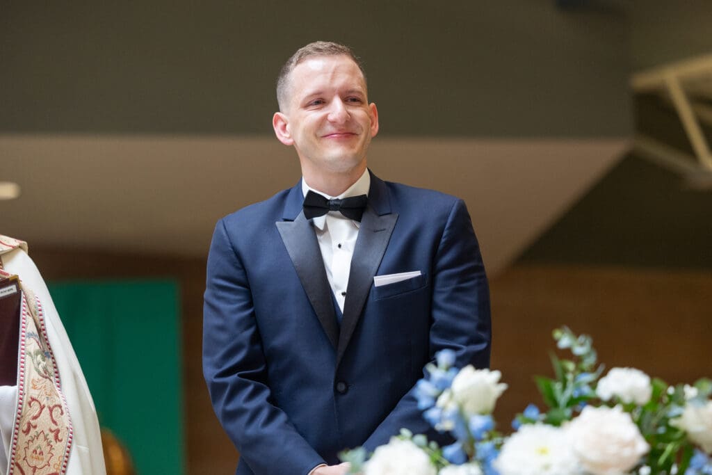 Groom waiting at the alter for his bride to come down the isle. 