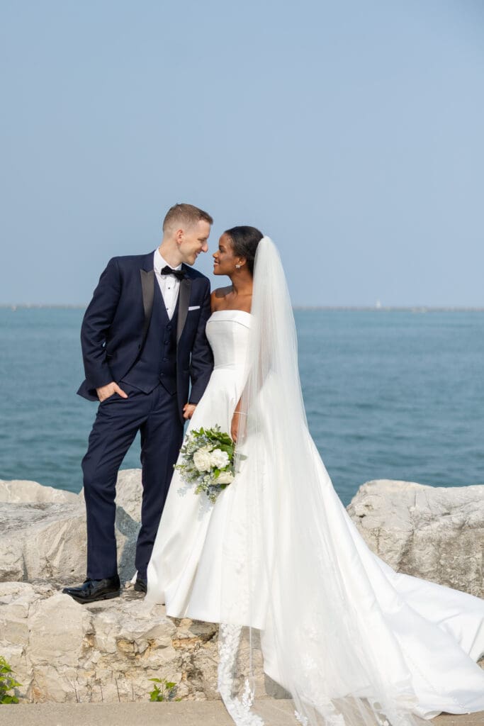 Bride and Groom on the rocks downtown Milwaukee on Lake Michigan.