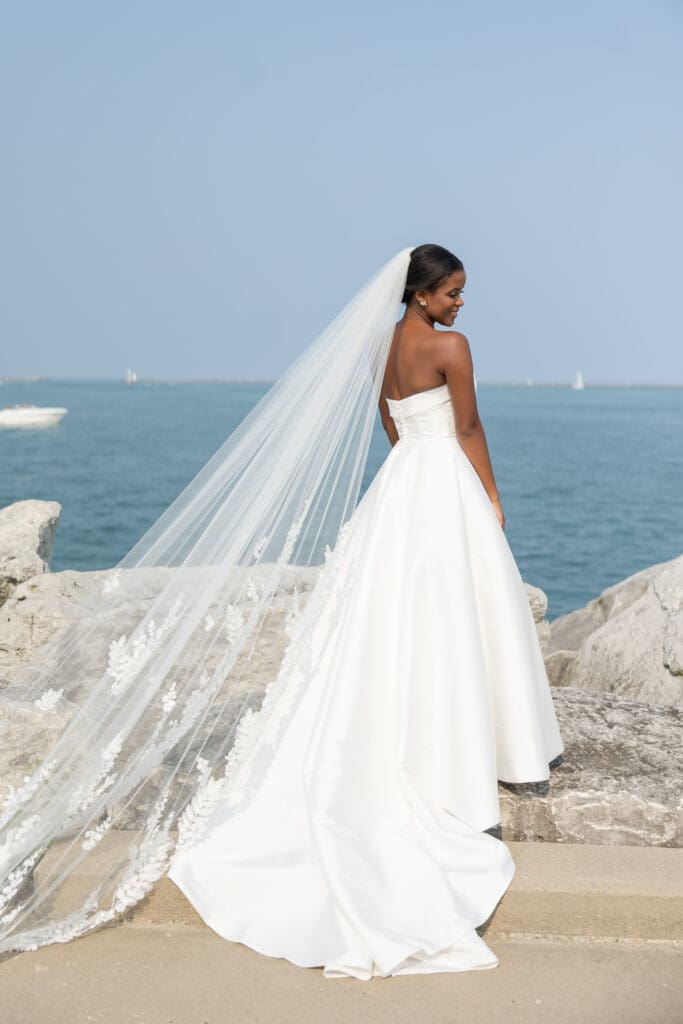 Bride on Lake Michigan with her gorgeous wedding dress. 