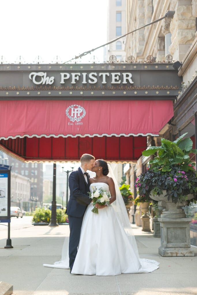 Bride and Groom kissing infront of The Pfister Hotel in Milwaukee, Wi.