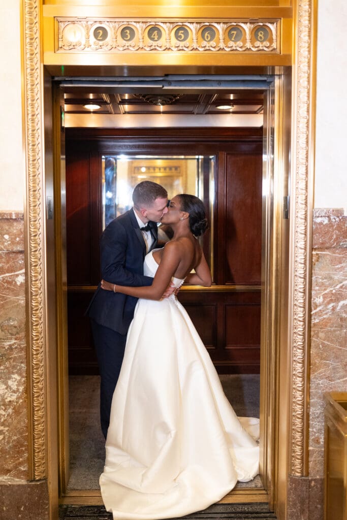 Bride and groom kissing in the elevator at the Pfister Hotel in Milwaukee, Wi. 