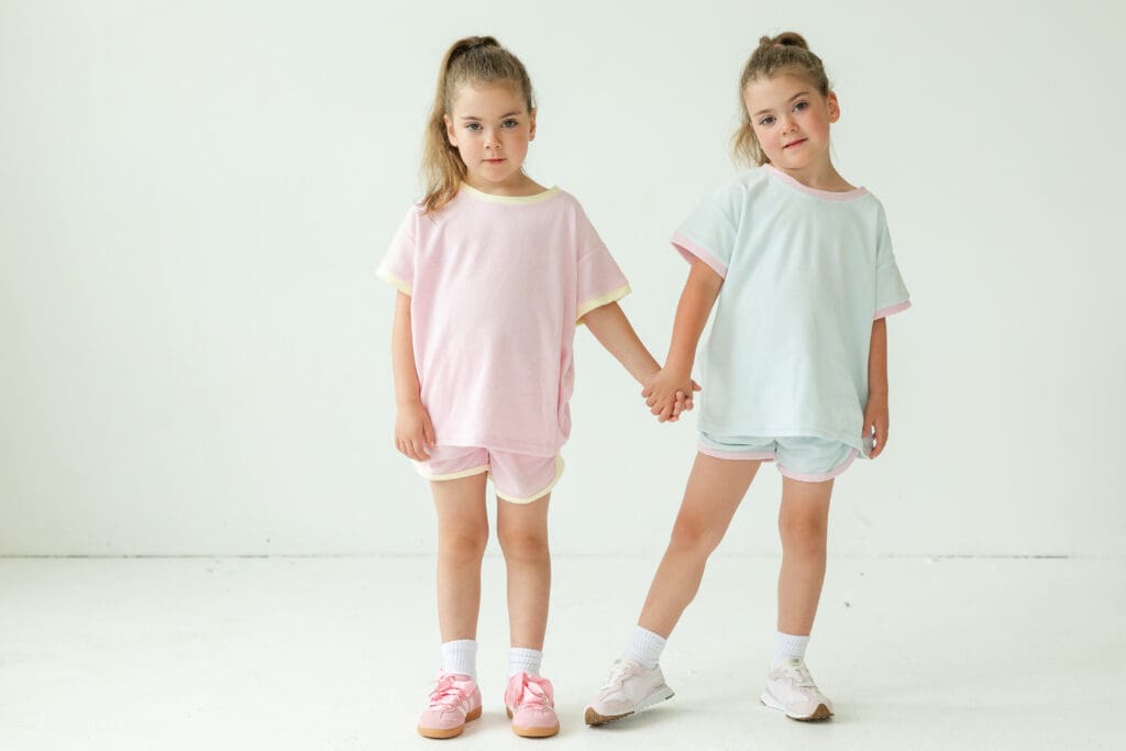 Sporty photo shoot with Milwaukee Photo Company. Two girls holding hands and posing for the camera.