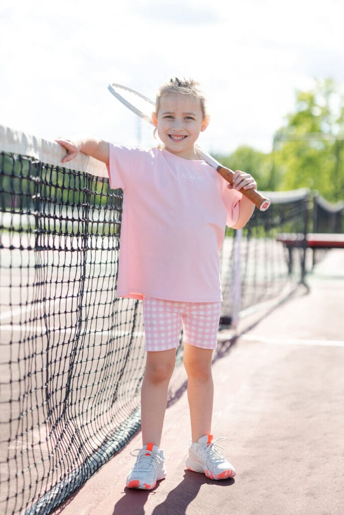 Girl doing a commerical photo shoot for Milwaukee Photo Company modeling sports wear for Alarae Kids Clothing.
