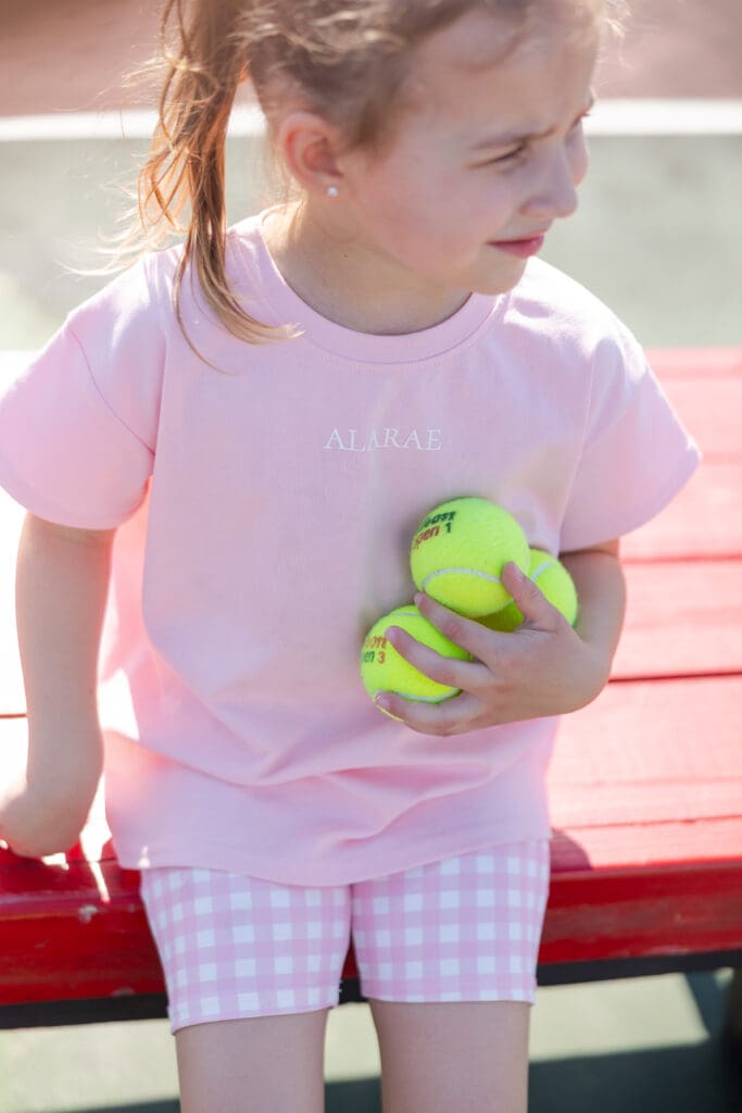 Girl holding tennis balls