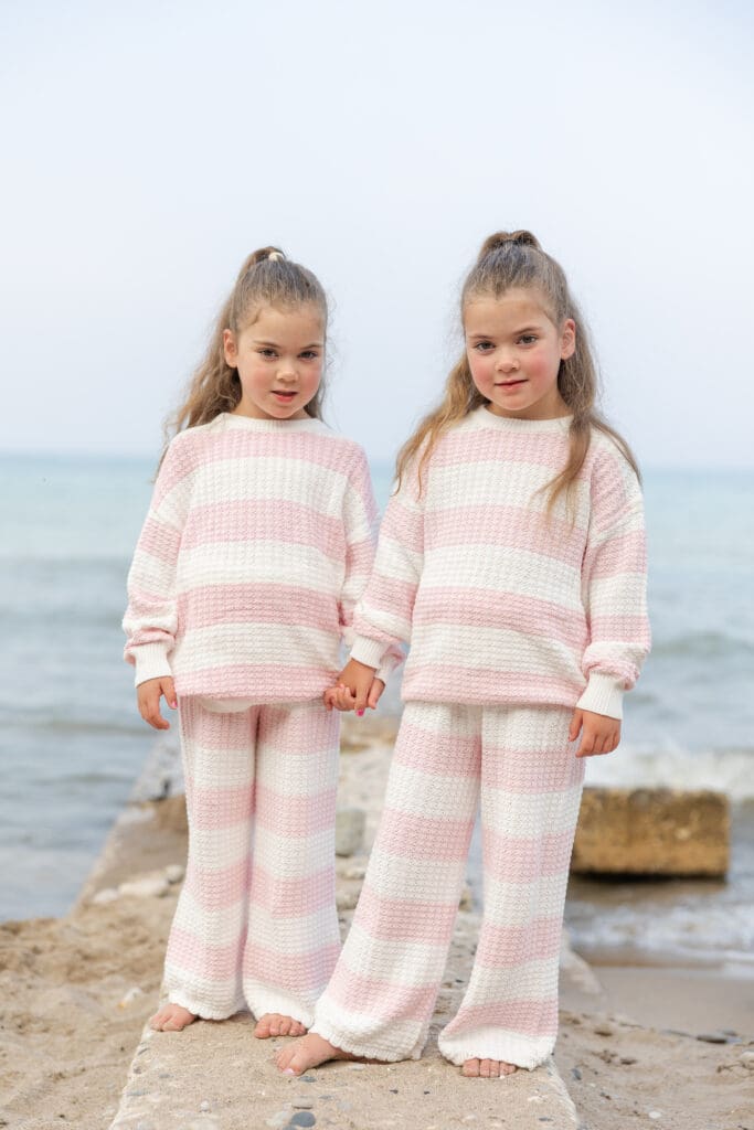 Girls holding hands in front of the shores of Lake Michigan