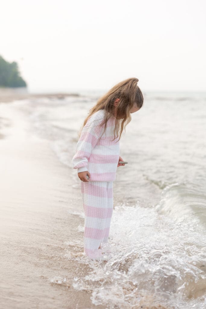 Girl with feet in the water on Lake Michigan