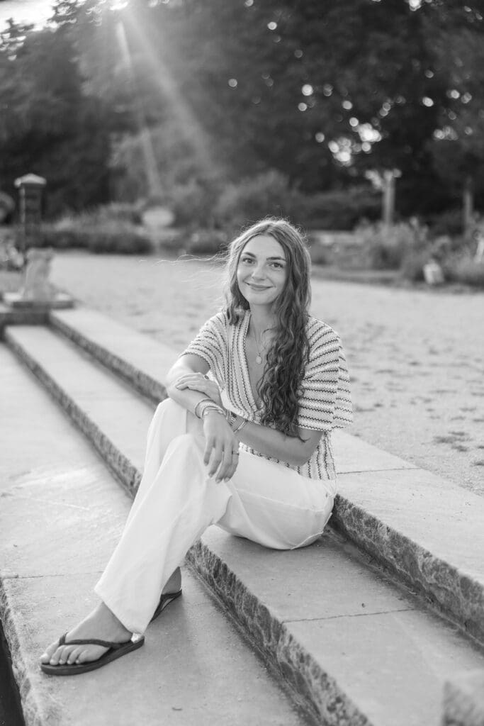 Young lady posing on cement stairs