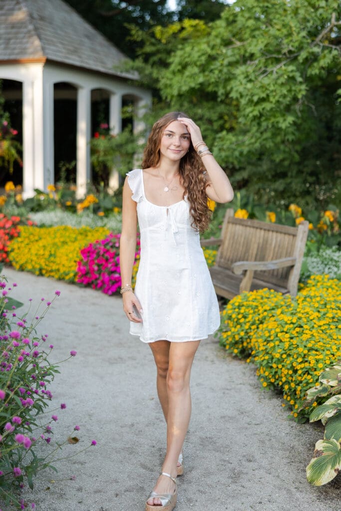 girl walking a path with flowers 