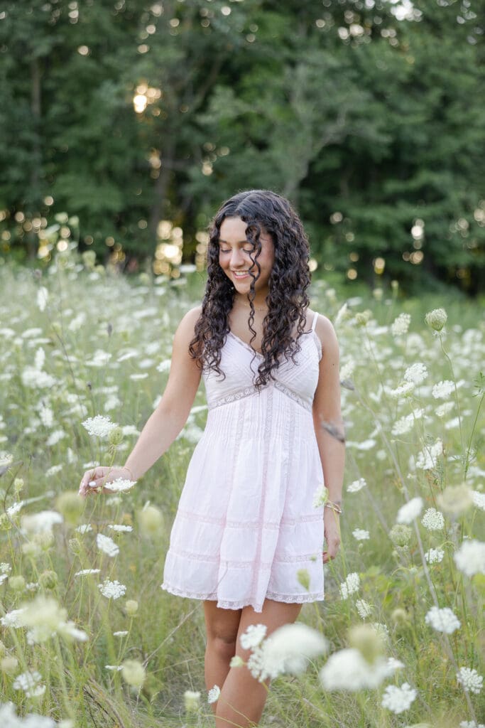 A beautiful young teenager in a field of white flowers at Mequon Nature Preserve.