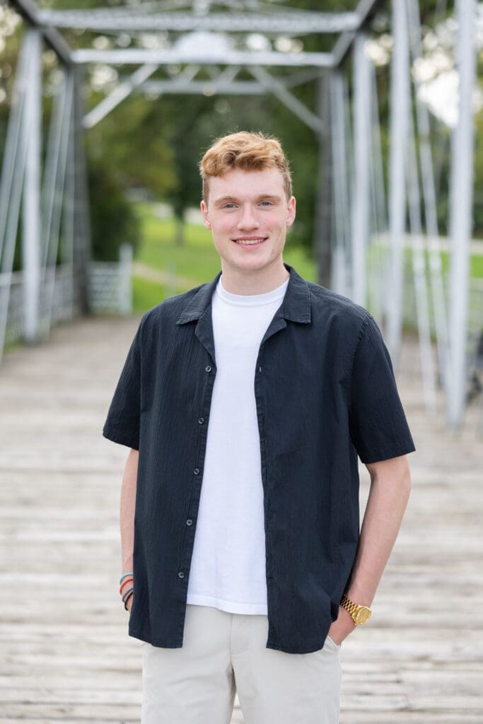 Senior in highschool smiling at the camera during his senior session