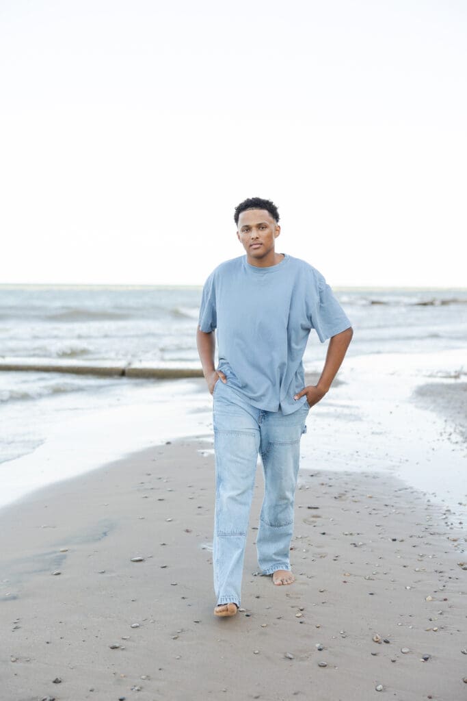 Young man walking on the beach 
