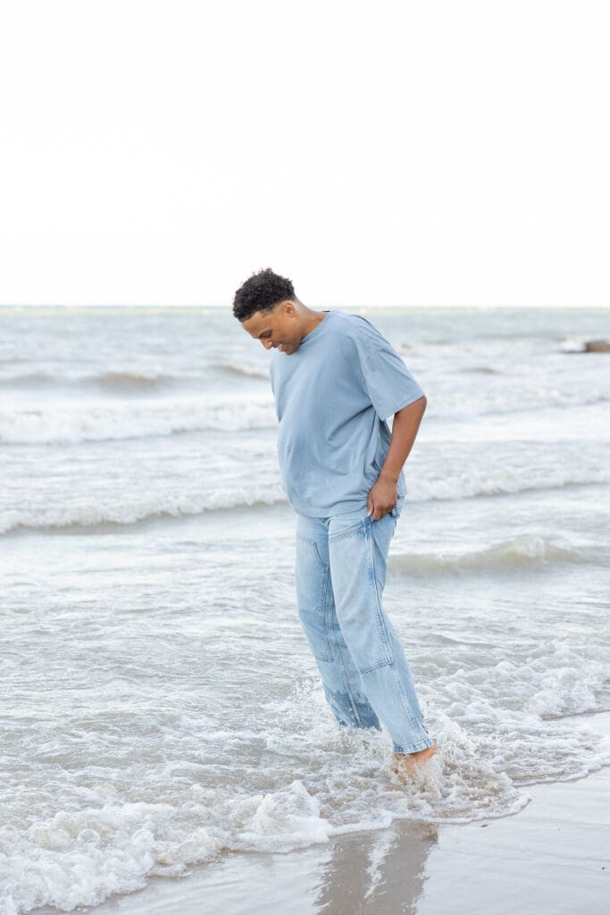 Young boy playing on the beach in the water