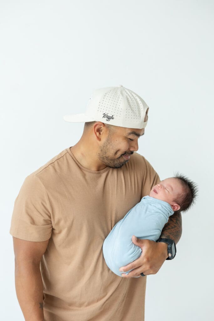 Milwaukee newborn photographer capturing baby Oliver with dad